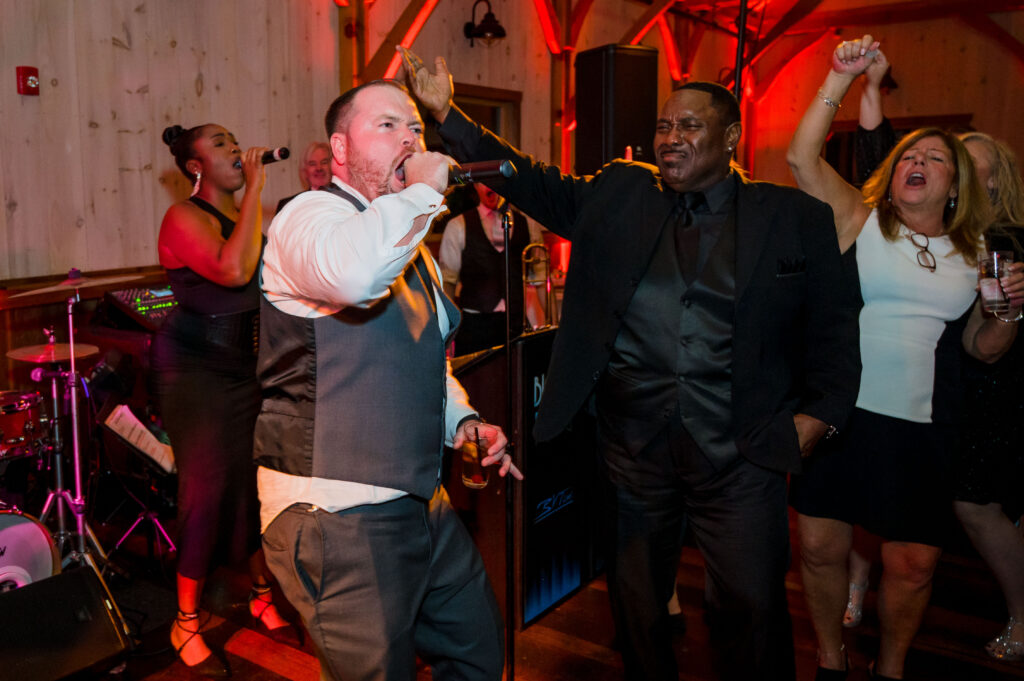BVTLive! Big Ric Rising wedding band performs at wedding with groom on stage by Versano Photography